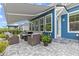 Inviting outdoor patio with comfortable seating, fire pit, and retractable awning for relaxing and entertaining at 117 Black Water Dr., Murrells Inlet, SC 29576