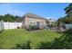Large backyard featuring a dining set, grill, hot tub, landscaping, and well-kept lawn at 1301 Camlet Ln., Little River, SC 29566