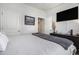 Bedroom with a TV mounted on the wall, view of artwork, and doorway to the next room at 1301 Camlet Ln., Little River, SC 29566