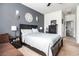 Bedroom featuring a gray accent wall, a bed with a light blue comforter, and views of the bathroom at 1301 Camlet Ln., Little River, SC 29566