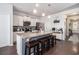 Modern kitchen with granite countertops, stainless steel appliances, and a functional island with barstool seating at 1301 Camlet Ln., Little River, SC 29566