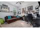 Bright home office featuring a comfy couch, decorative shelves, and a large desk at 1301 Camlet Ln., Little River, SC 29566