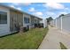 View of a cozy fenced backyard, showing a small patio area with outdoor seating and a well-maintained lawn at 1311 Turkey Ridge Rd. # A, Surfside Beach, SC 29575