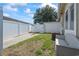Well-maintained backyard with a lush green lawn, white fencing, and a bench for outdoor seating at 1311 Turkey Ridge Rd. # A, Surfside Beach, SC 29575