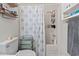 Bathroom shower with a white and floral shower curtain and built-in shelving at 1311 Turkey Ridge Rd. # A, Surfside Beach, SC 29575