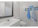 Bathroom with a single sink vanity and wood look shelf with decor and towels at 1311 Turkey Ridge Rd. # A, Surfside Beach, SC 29575