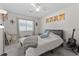 Bedroom with carpet flooring, window, and bed with plush blanket and guitar at 1311 Turkey Ridge Rd. # A, Surfside Beach, SC 29575