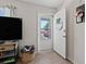 View of entryway with open door, TV, and updated flooring at 1311 Turkey Ridge Rd. # A, Surfside Beach, SC 29575