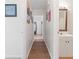 Hallway leading to a bathroom with modern decor and wood look floors at 1311 Turkey Ridge Rd. # A, Surfside Beach, SC 29575