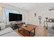 Spacious living room with hardwood floors and modern TV at 1311 Turkey Ridge Rd. # A, Surfside Beach, SC 29575