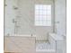 Bathroom showcasing an elegant all-tile walk-in shower featuring a glass door and built-in benches at 1409 Ashwood Circle, Surfside Beach, SC 29575