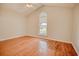 Bedroom featuring a vaulted ceiling, hardwood floors, and a large window at 1409 Ashwood Circle, Surfside Beach, SC 29575