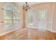 Dining room featuring hardwood floors, arched windows, and a chandelier providing a bright and inviting space at 1409 Ashwood Circle, Surfside Beach, SC 29575