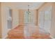 Bright dining room featuring hardwood floors, large windows, and a stylish chandelier at 1409 Ashwood Circle, Surfside Beach, SC 29575