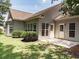 Rear exterior view of the home highlighting the patio, yard, and multiple windows that provide ample natural light at 1409 Ashwood Circle, Surfside Beach, SC 29575