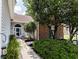 Inviting front entrance with a well-manicured lawn, a curved glass storm door, and brick accents at 1409 Ashwood Circle, Surfside Beach, SC 29575