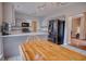 Open concept kitchen with breakfast bar, stainless steel appliances, and access to the dining and living areas at 1409 Ashwood Circle, Surfside Beach, SC 29575
