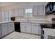 Well-lit kitchen featuring granite countertops, stainless steel appliances, and tile flooring at 1409 Ashwood Circle, Surfside Beach, SC 29575