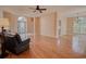 Open-concept living room featuring hardwood floors, arched windows, and ample natural light at 1409 Ashwood Circle, Surfside Beach, SC 29575