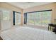 Bright sunroom with tiled floor, ceiling fan, and lots of natural light from the many windows and door at 1409 Ashwood Circle, Surfside Beach, SC 29575