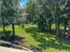 Expansive backyard overlooking the lake, offering lush greenery and mature trees for shade and privacy at 145 Hartland Dr. # 4-E, Myrtle Beach, SC 29572