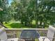 Enjoy scenic lake views from this cozy balcony with a glass-top table and chairs for outdoor relaxation at 145 Hartland Dr. # 4-E, Myrtle Beach, SC 29572