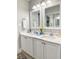 Bathroom featuring double vanity with marble countertop and cabinets at 145 Hartland Dr. # 4-E, Myrtle Beach, SC 29572