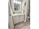 Well-lit bathroom features a vanity with white cabinetry and a neutral countertop, complemented by wood-look flooring at 145 Hartland Dr. # 4-E, Myrtle Beach, SC 29572