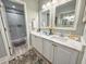 Bathroom featuring a double vanity with marble countertops and a glass enclosed tile shower at 145 Hartland Dr. # 4-E, Myrtle Beach, SC 29572