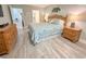 Bedroom showcasing a wooden bed frame with coordinated bedding and a dresser with a lamp on top at 145 Hartland Dr. # 4-E, Myrtle Beach, SC 29572
