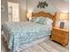 Bedroom featuring a wooden bed frame, matching nightstand with lamp, and view to the bathroom at 145 Hartland Dr. # 4-E, Myrtle Beach, SC 29572