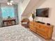 Bright bedroom featuring a ceiling fan, desk by the window, and a dresser with a flat-screen TV at 145 Hartland Dr. # 4-E, Myrtle Beach, SC 29572