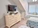 Bedroom with three twin beds and dresser with mounted TV at 145 Hartland Dr. # 4-E, Myrtle Beach, SC 29572