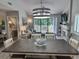 Open dining room with wood table, decorative lighting and access to the outdoor deck at 145 Hartland Dr. # 4-E, Myrtle Beach, SC 29572