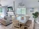 Open living and dining area with wood table, overhead lighting, and a fireplace at 145 Hartland Dr. # 4-E, Myrtle Beach, SC 29572