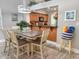 Open dining area with wood table with seating, decorative lighting and kitchen views at 145 Hartland Dr. # 4-E, Myrtle Beach, SC 29572