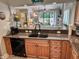 Open kitchen with granite counters, wood cabinets, and black dishwasher at 145 Hartland Dr. # 4-E, Myrtle Beach, SC 29572