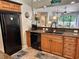 Modern kitchen with black appliances, wood cabinets, and wood-style flooring at 145 Hartland Dr. # 4-E, Myrtle Beach, SC 29572