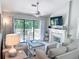 Spacious living room with a modern fireplace, sliding glass doors to a private balcony, and stylish furnishings at 145 Hartland Dr. # 4-E, Myrtle Beach, SC 29572