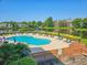 Stunning view of the outdoor pool and deck area with lounge chairs overlooking a beautiful community lake at 145 Hartland Dr. # 4-E, Myrtle Beach, SC 29572