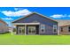 Backyard exterior view of home with siding, sliding glass doors to covered patio, and green lawn at 1534 Breakwater Dr., Little River, SC 29566
