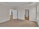 Spacious bedroom with two open doorways and neutral tones at 1534 Breakwater Dr., Little River, SC 29566