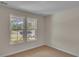Cozy bedroom featuring two windows showcasing the outdoor neighborhood view at 1534 Breakwater Dr., Little River, SC 29566