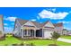 Front exterior of a home with blue siding, a two-car garage, and a beautifully landscaped front yard at 1534 Breakwater Dr., Little River, SC 29566