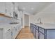 Modern kitchen featuring stainless appliances, white cabinets, an island with sink, and wood-style flooring at 1534 Breakwater Dr., Little River, SC 29566