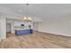 Open kitchen/dining area with wood flooring, island, stainless appliances, and white cabinets at 1534 Breakwater Dr., Little River, SC 29566