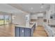 Open kitchen and living room concept with island, stainless appliances, and backyard views at 1534 Breakwater Dr., Little River, SC 29566