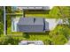 A high angle shot of a home's roof, backyard pool, and drive with lush green grass at 1718 26Th Ave. N, North Myrtle Beach, SC 29582