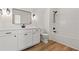 Bathroom with vanity, sink, lighting, bathtub, and shower with black hardware at 1718 26Th Ave. N, North Myrtle Beach, SC 29582