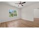 Bedroom with hardwood floors, a ceiling fan, and a large window at 1718 26Th Ave. N, North Myrtle Beach, SC 29582